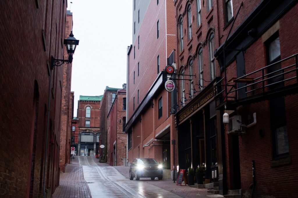 Back alleyway in Saint John with a car in the rain