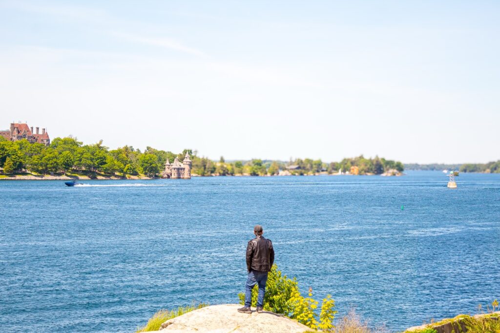 Man Standing Next to Cliff